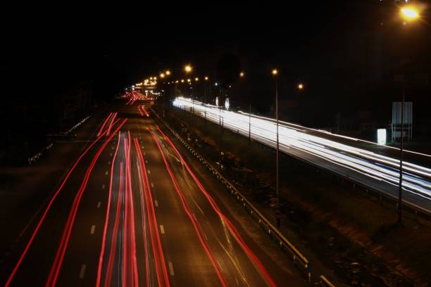 istock Light of a car running on the road at night 1133802854