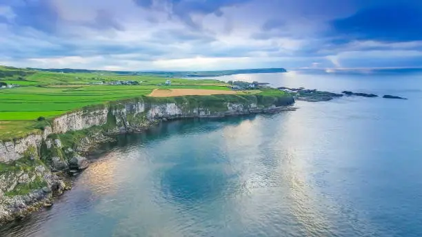 Aerial landscape view of the sea and the cliff in Carrick-a-Rede Rope Bridge tourist destination in North Ireland in Ireland