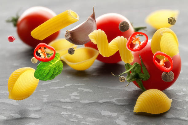 istock Ingredients for cooking Italian pasta thrown into the air. 1133803063