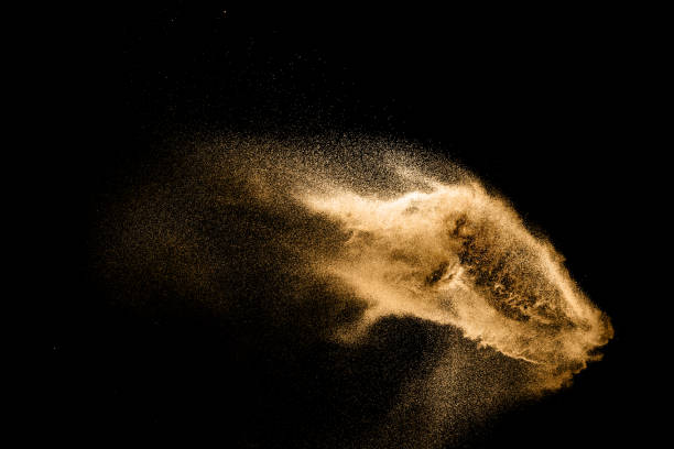 istock Golden sand explosion isolated on black background. Abstract sand cloud. Golden colored sand splash against dark background. Yellow sand fly wave in the air. 1133803513
