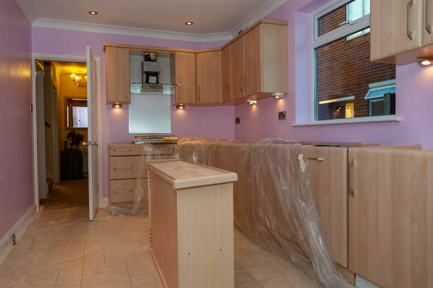 Scene inside a house undergoing a kitchen refurbishment after the cabinets are partially fitted and the appliances installed.