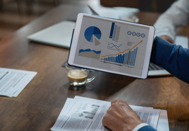 istock Close up of unrecognizable man holding a tablet displaying infographics 1133808055