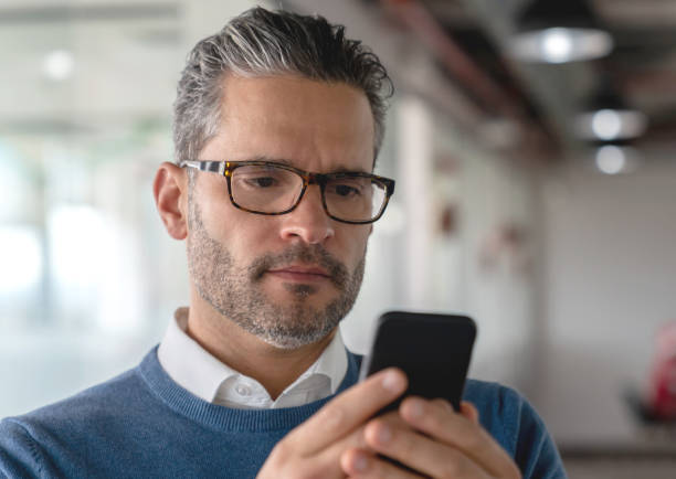 istock Handsome businessman reading a text on smartphone looking serious 1133808058