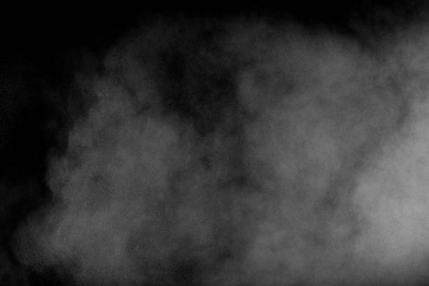 istock White dust exhale in the air. Motion powder spray burst in dark background. 1133808638