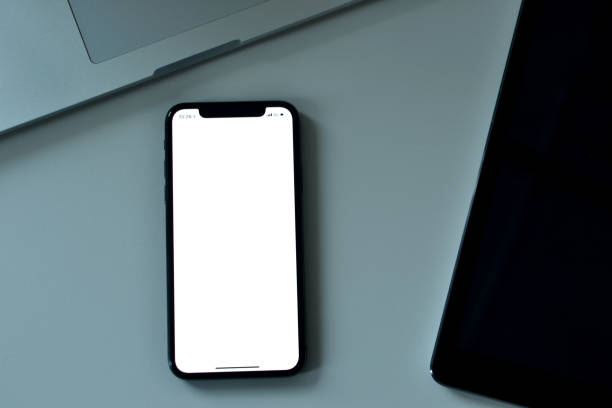 istock A smart phone is focused between a laptop and a tablet device 1133809986