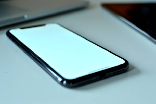 istock A smart phone is focused between a laptop and a tablet device 1133810291