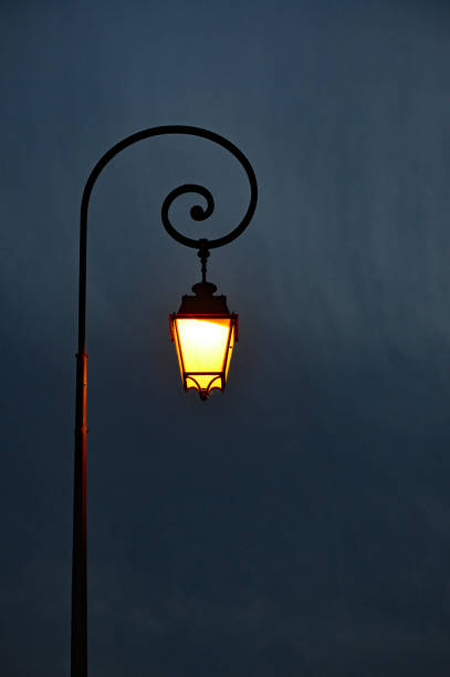 Single lamp post against dark background