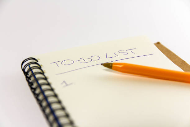 istock To do list in spiral notepad. White background, flat lay style. 1133811442