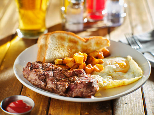istock steak and eggs breakfast on wooden table with ketchup 1133811536