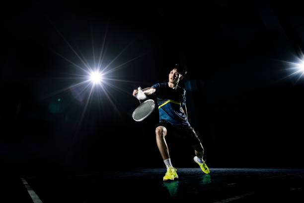 istock Asian badminton player is hitting in court 1133813513