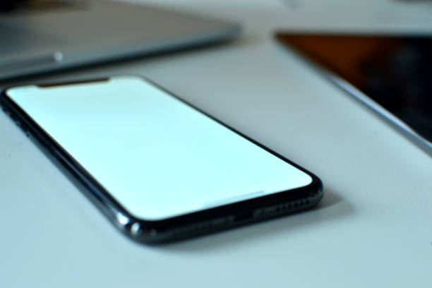 istock A smart phone is focused between a laptop and a tablet device 1133814130