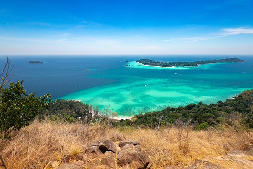 This photo was taken over Koh Lipe with the blue sky background and green crystal clear water.
