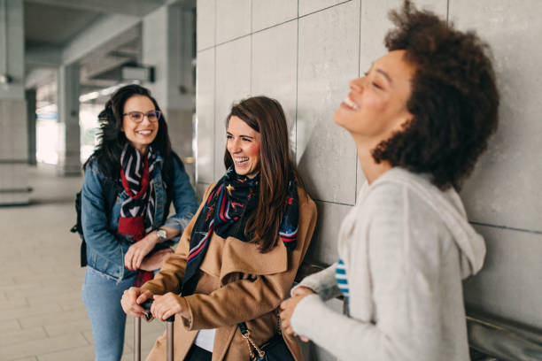istock Three friends with suitcases travel together 1133819540