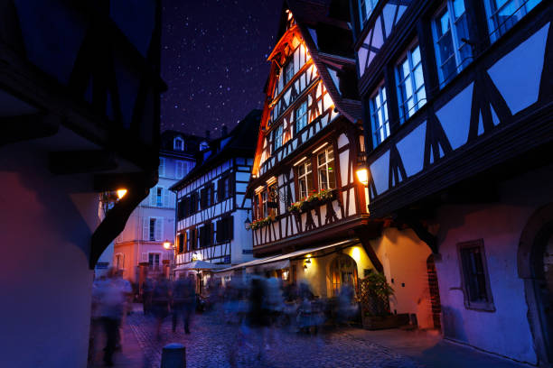 Beautiful view of Strasbourg streets at night Beautiful view of Strasbourg streets with traditional French houses at night petite france strasbourg stock pictures, royalty-free photos & images