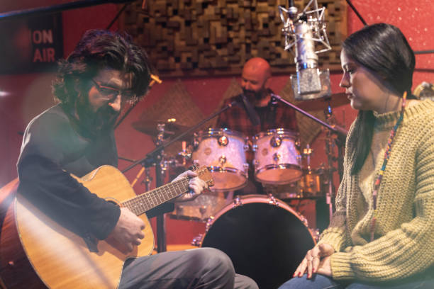 istock Music group performing for recording in sound studio 1133823594