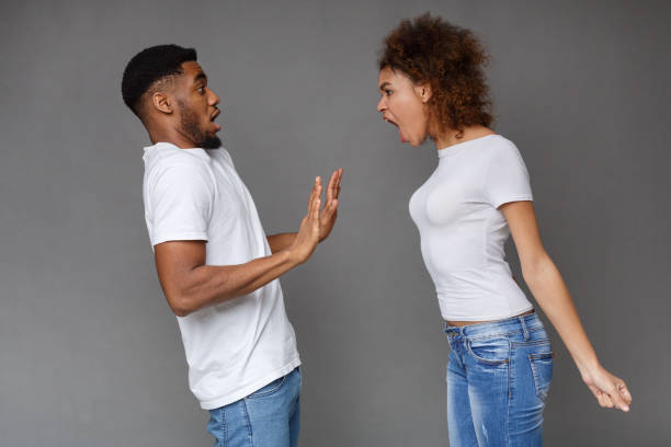 istock Angry woman shouting at man over gray background 1133825482