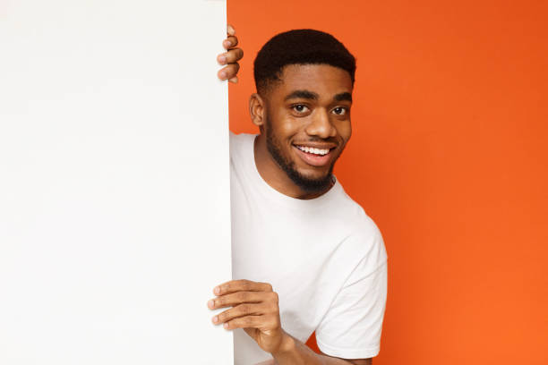 istock Young black man showing and displaying empty placard 1133825484