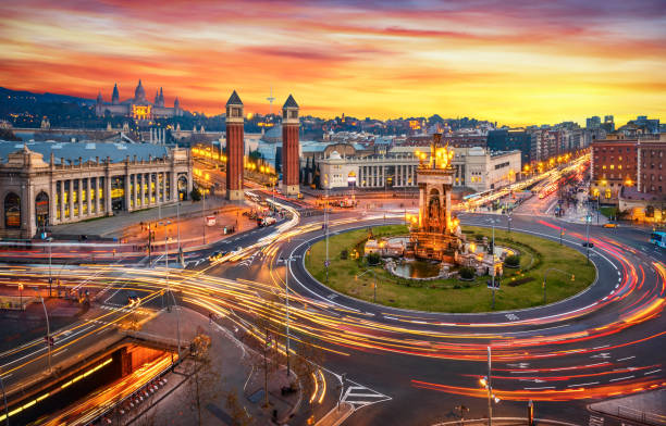 Plaça d'espanya (Plaza de españa - spain square) long exposure at sunset in Barcelona Long exposure photo of Fira de Barcelona, Plaça d'espanya (Spain square) and montjuic mountain in Barcelona at sunset with car light trails . Spain high dynamic range imaging photos stock pictures, royalty-free photos & images