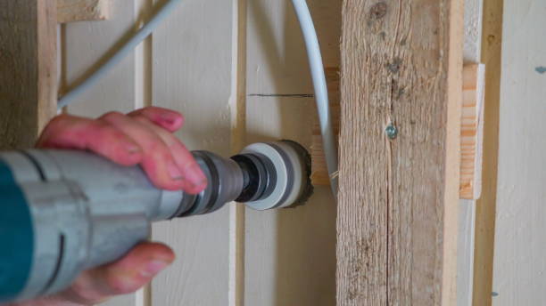 istock A man making a hole on the wooden wall 1133827592