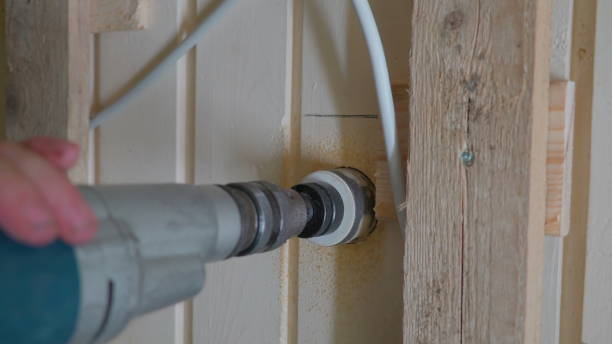 istock A drilling tool making a hole on the wooden wall 1133827612