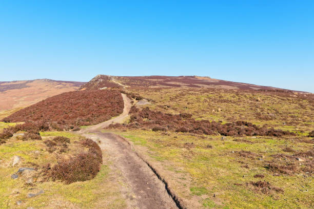 istock Narrow footpath winds up Derwent Moor in the Derbyshire Peak District. 1133829228