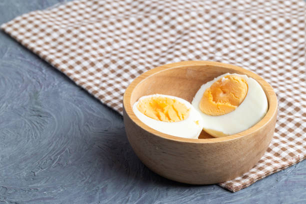 istock close up of half boiled eggs on wooden bowl 1133830900