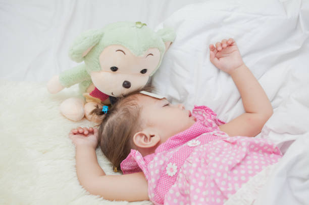istock Kid girls sleep happily into bed. 1133831467