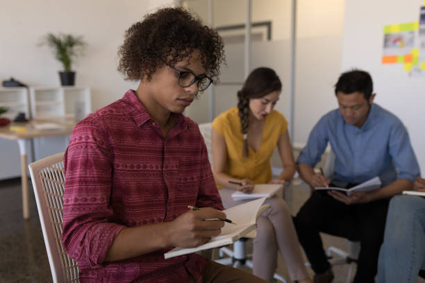 istock Male executive writing on a diary in office 1133832078