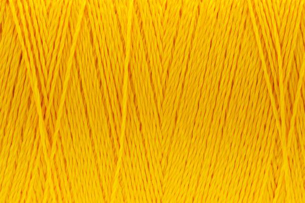istock Macro picture of thread texture dark yellow color background 1133834265