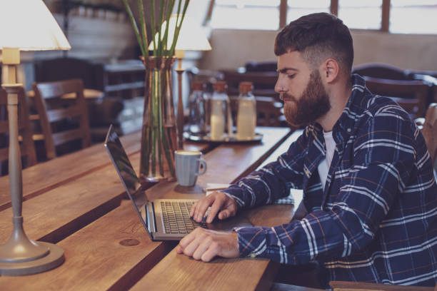 istock Young professional surfing the Internet on his laptop in a cafe 1133834308