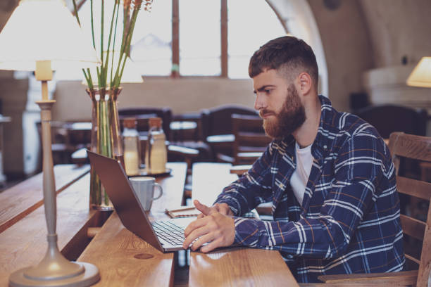 istock Young professional surfing the Internet on his laptop in a cafe 1133834321