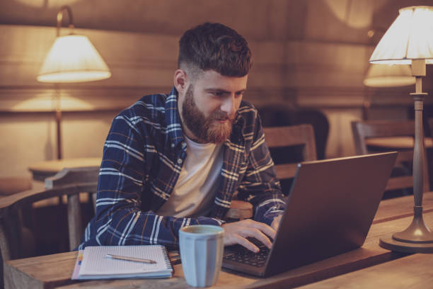 istock Young professional surfing the Internet on his laptop in a cafe 1133834403
