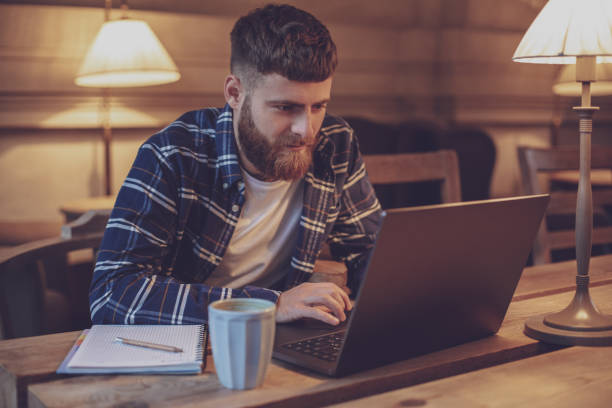 istock Young professional surfing the Internet on his laptop in a cafe 1133834405