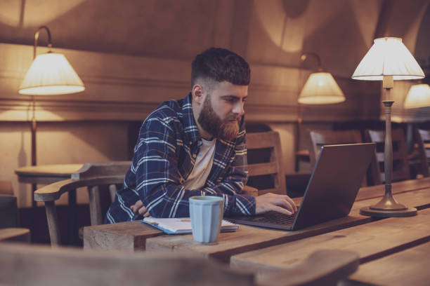 istock Young professional surfing the Internet on his laptop in a cafe 1133834408
