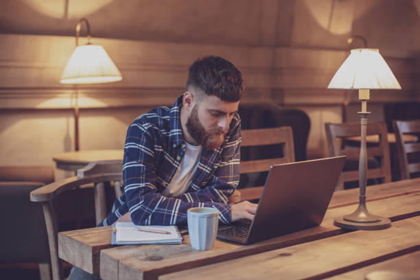 istock Young professional surfing the Internet on his laptop in a cafe 1133834410