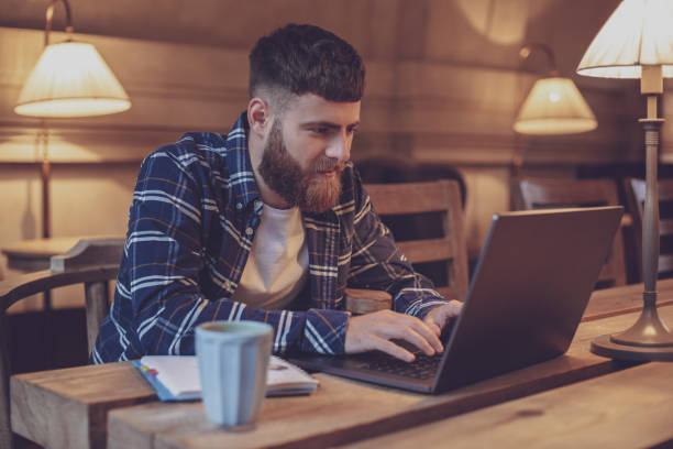 istock Young professional surfing the Internet on his laptop in a cafe 1133834415