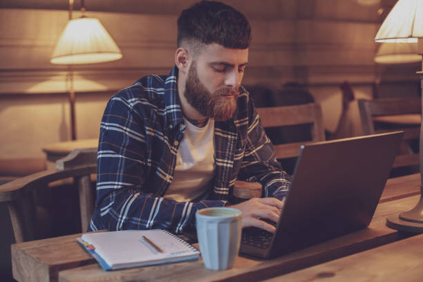 istock Young professional surfing the Internet on his laptop in a cafe 1133834450