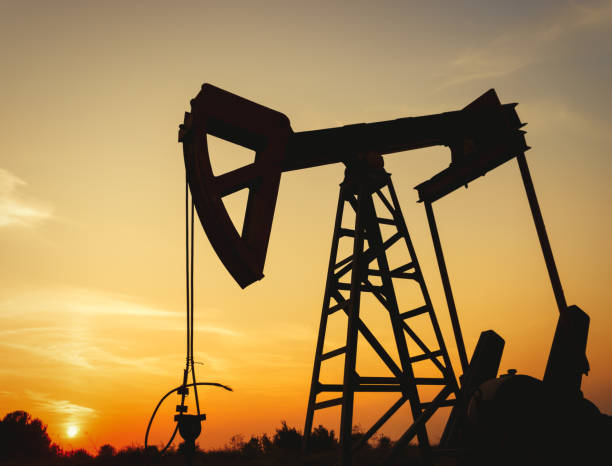 istock Oil rig working on a golden sunset 1133834616