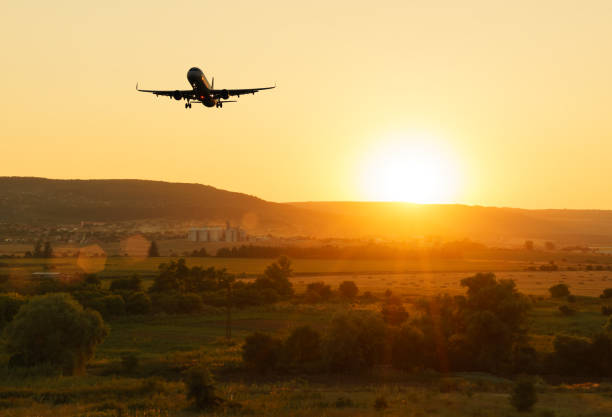 istock Aircraft flying in the sky against a background of a bright sunset. Basic background for design 1133836133