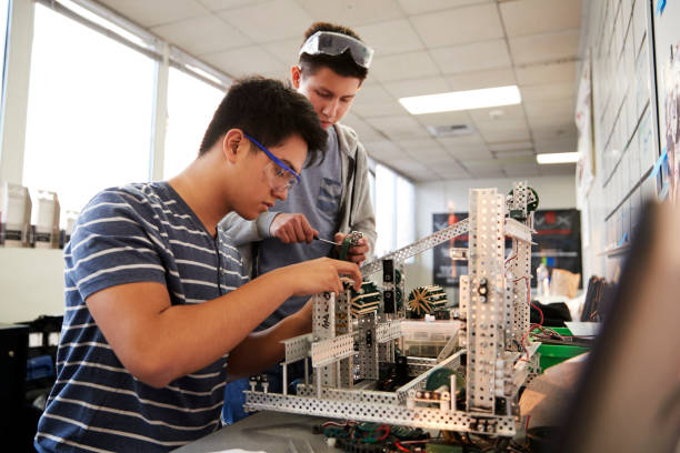 istock Two Male College Students Building Machine In Science Robotics Or Engineering Class 1133836147