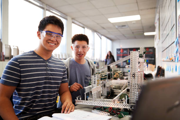 istock Portrait Of Two Male College Students Building Machine In Science Robotics Or Engineering Class 1133836220