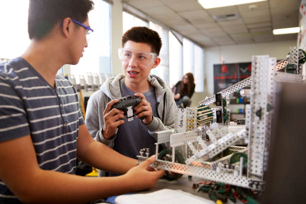 istock Two Male College Students Building Machine In Science Robotics Or Engineering Class 1133836250