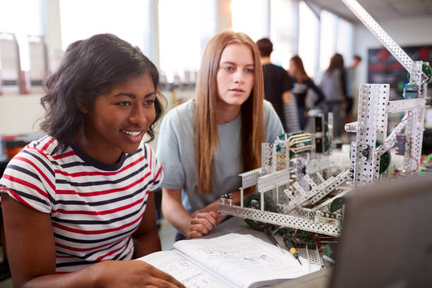 istock Two Female College Students Building Machine In Science Robotics Or Engineering Class 1133836258