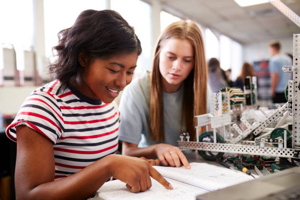 istock Two Female College Students Building Machine In Science Robotics Or Engineering Class 1133836288