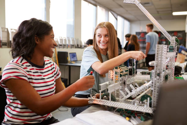 istock Two Female College Students Building Machine In Science Robotics Or Engineering Class 1133836300
