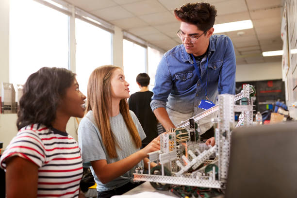 istock Teacher With Two Female College Students Building Machine In Science Robotics Or Engineering Class 1133836309