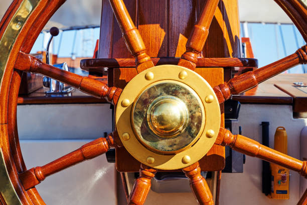istock Wooden sailing ship steering wheel close-up 1133836375