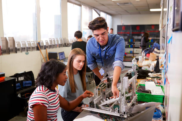 istock Teacher With Two Female College Students Building Machine In Science Robotics Or Engineering Class 1133836400