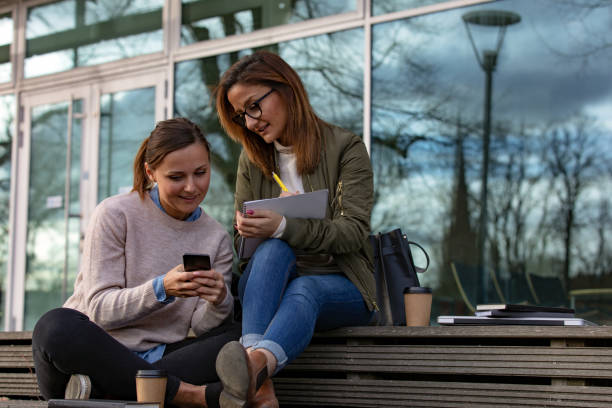 istock Two female students looking at phone 1133836438