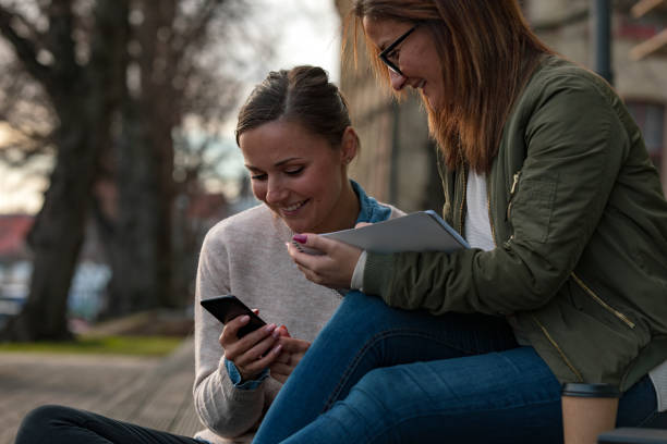 istock Two female students looking at phone 1133836465